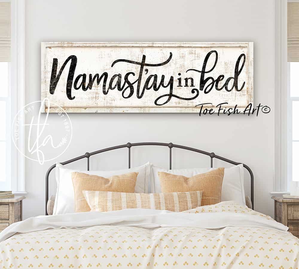Namast'ay In Bed Sign handmade by ToeFishArt. Original, custom, personalized wall decor signs. Canvas, Wood or Metal. Rustic modern farmhouse, cottagecore, vintage, retro, industrial, Americana, primitive, country, coastal, minimalist.