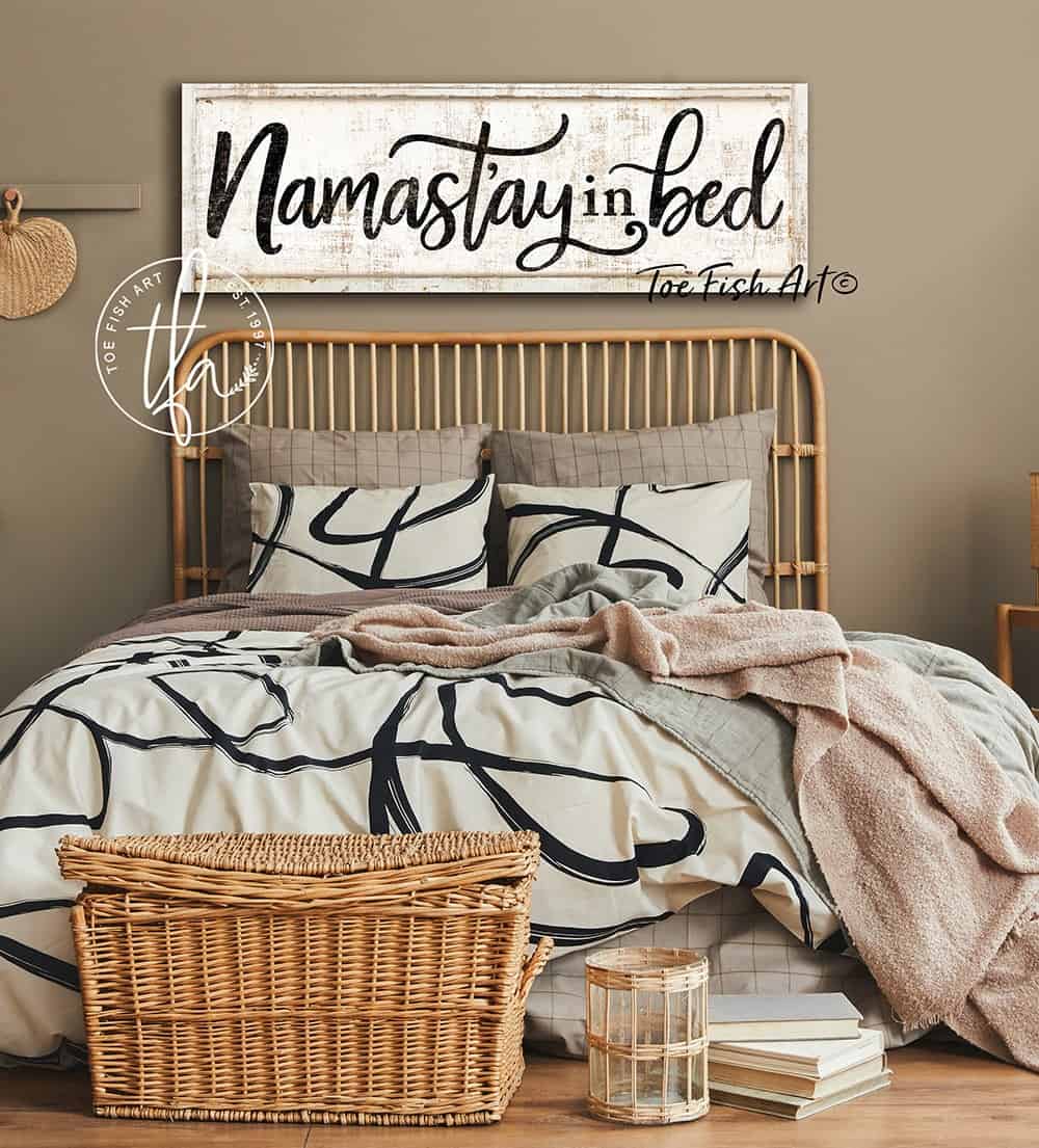 Namast'ay In Bed Sign handmade by ToeFishArt. Original, custom, personalized wall decor signs. Canvas, Wood or Metal. Rustic modern farmhouse, cottagecore, vintage, retro, industrial, Americana, primitive, country, coastal, minimalist.