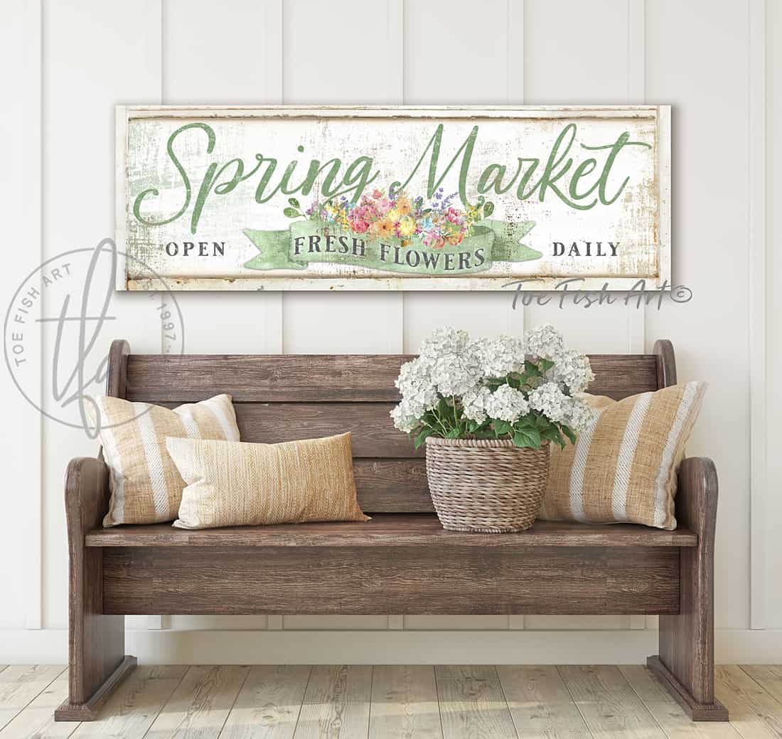 Spring Market Fresh Flower Bouquet Cursive Sign handmade by ToeFishArt hanging above amish wooden bench against creamy white vertical shiplap wall. Original, custom, personalized gifts and wall decor signs. Canvas, Wood or Metal. Rustic modern farmhouse, cottagecore, vintage, retro, industrial, Americana, primitive, country, coastal, minimalist.