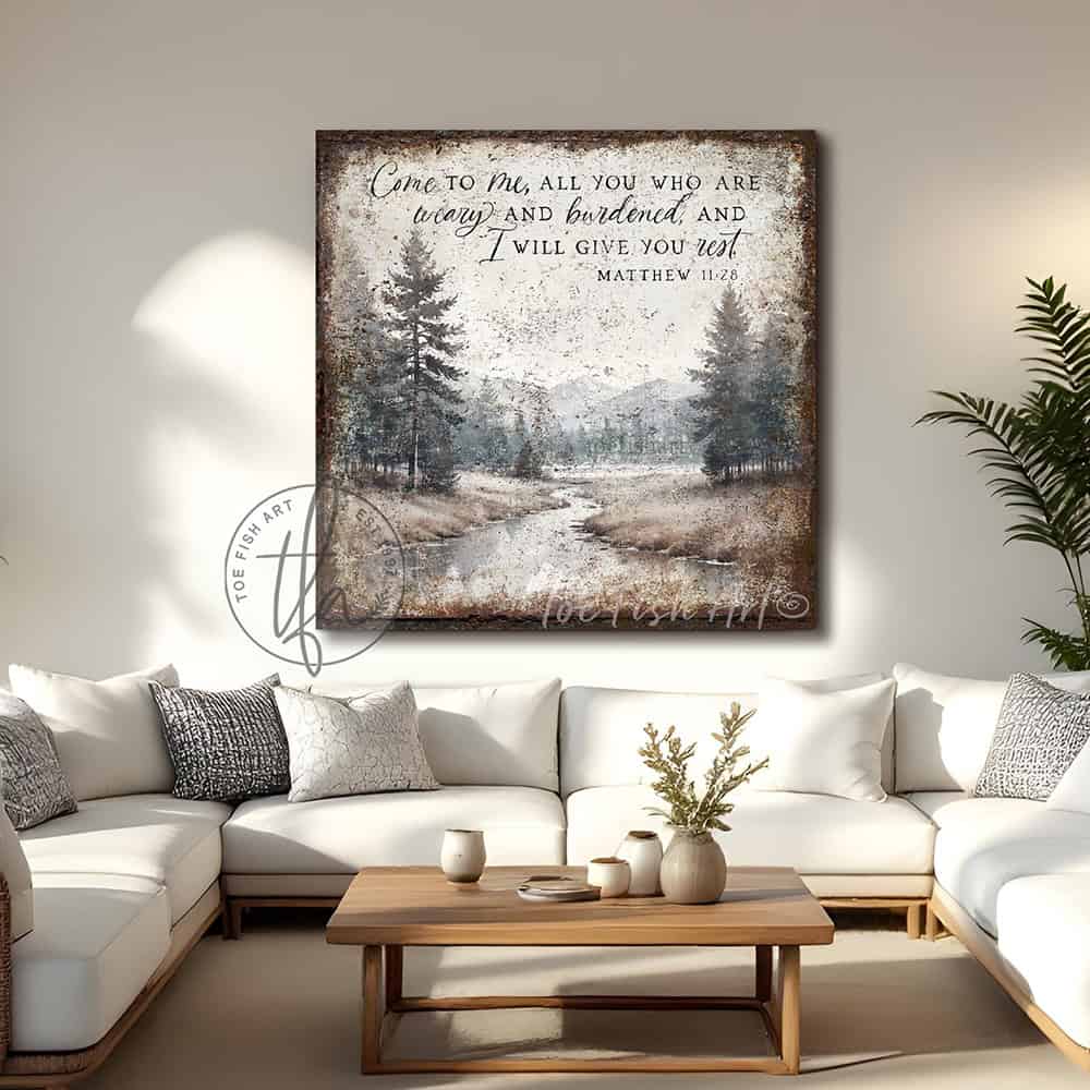 Decorate your home with words that inspire and bring peace to your space with our Vintage Scripture Wall Art 'Come To Me All Who Are Weary' Matthew 11:28, featuring a serene forested river and mountain range painting. Be surrounded by decor you LOVE! Choose premium gallery-stretched canvas or elegant framed canvas. Toe Fish Art makes artisan wall art with American materials. Proudly Made in the USA, each piece is expertly constructed with genuine craftsmanship, heritage quality, and rustic charm.