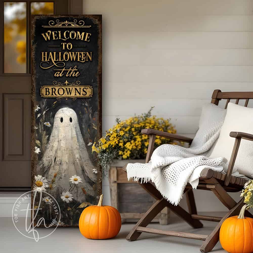 Toe Fish Art’s ‘Welcome to Halloween’ sign features a charming ghost 'pushing up daisies' in a whimsical floral design. Available as a wood-framed canvas or outdoor weatherproof metal, this vertical cottagecore-style sign is personalized with your family name and perfect for greeting guests on your front porch, entryway, or patio. Handmade in the USA and built to last with genuine craftsmanship, this rustic Halloween decor blends vintage charm with playful seasonal style for a warm and spooky welcome.