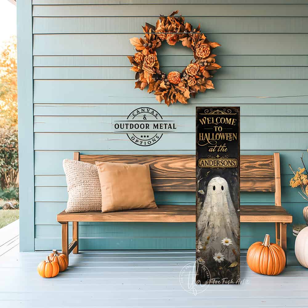 Toe Fish Art’s ‘Welcome to Halloween’ sign features a charming ghost 'pushing up daisies' in a whimsical floral design. Available as a wood-framed canvas or outdoor weatherproof metal, this vertical cottagecore-style sign is personalized with your family name and perfect for greeting guests on your front porch, entryway, or patio. Handmade in the USA and built to last with genuine craftsmanship, this rustic Halloween decor blends vintage charm with playful seasonal style for a warm and spooky welcome.