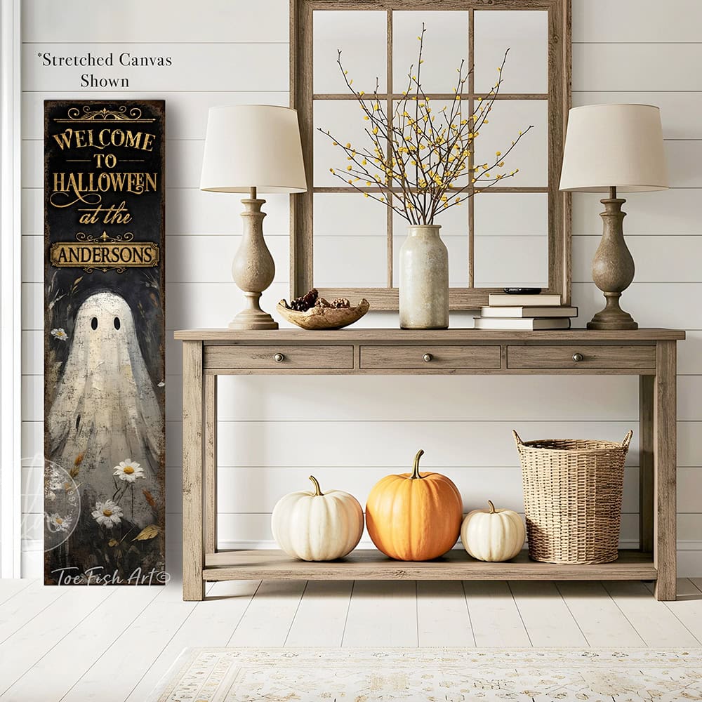 Toe Fish Art’s ‘Welcome to Halloween’ sign features a charming ghost 'pushing up daisies' in a whimsical floral design. Available as a wood-framed canvas or outdoor weatherproof metal, this vertical cottagecore-style sign is personalized with your family name and perfect for greeting guests on your front porch, entryway, or patio. Handmade in the USA and built to last with genuine craftsmanship, this rustic Halloween decor blends vintage charm with playful seasonal style for a warm and spooky welcome.