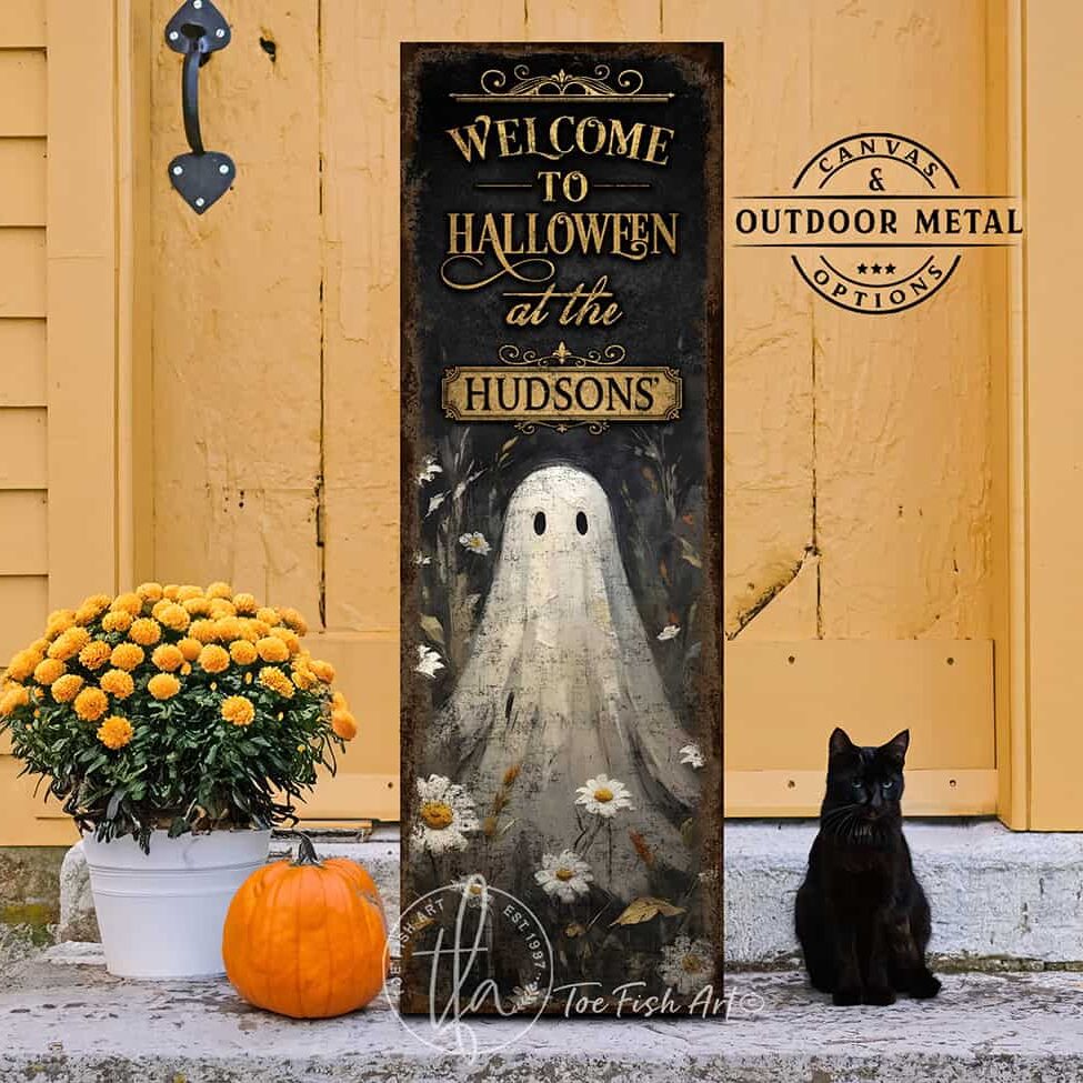 Toe Fish Art’s ‘Welcome to Halloween’ sign features a charming ghost 'pushing up daisies' in a whimsical floral design. Available as a wood-framed canvas or outdoor weatherproof metal, this vertical cottagecore-style sign is personalized with your family name and perfect for greeting guests on your front porch, entryway, or patio. Handmade in the USA and built to last with genuine craftsmanship, this rustic Halloween decor blends vintage charm with playful seasonal style for a warm and spooky welcome.
