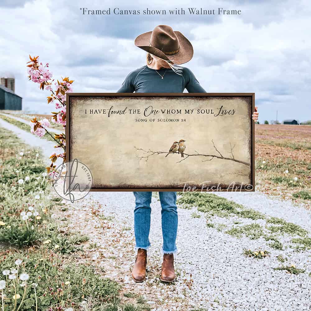 This faith-based wall decor brings the message "I Have Found the One Whom My Soul Loves" to your home through a quaint depiction of two love birds sharing a quiet moment. The artwork conveys a sense of peace, calm, and deep connection. Choose between premium framed canvas or durable outdoor metal. Toe Fish Art makes artisan wall art with American materials. Proudly Made in the USA, each piece is expertly constructed with genuine craftsmanship, heritage quality, and rustic charm.