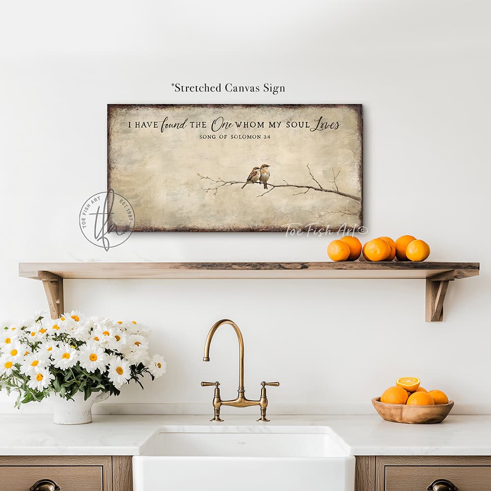 This faith-based wall decor brings the message "I Have Found the One Whom My Soul Loves" to your home through a quaint depiction of two love birds sharing a quiet moment. The artwork conveys a sense of peace, calm, and deep connection. Choose between premium framed canvas or durable outdoor metal. Toe Fish Art makes artisan wall art with American materials. Proudly Made in the USA, each piece is expertly constructed with genuine craftsmanship, heritage quality, and rustic charm.