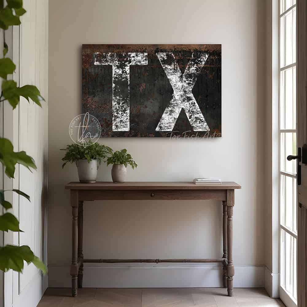 Personalized USA state location wall art featuring your custom two-letter state abbreviation on a dark, distressed industrial farmhouse background with vintage rustic charm and faded white lettering. Be surrounded by decor you LOVE! Choose between premium framed canvas or durable outdoor metal. Toe Fish Art makes artisan wall art with American materials. Proudly Made in the USA, each piece is expertly constructed with genuine craftsmanship, heritage quality, and rustic charm.