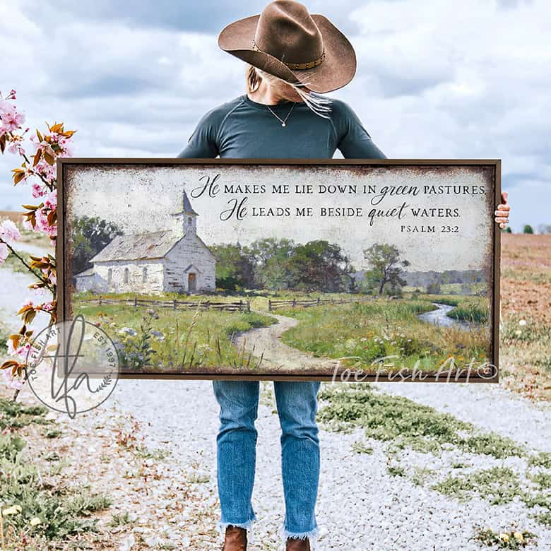 This Psalm 23:2 vintage landscape painting by Toe Fish Art captures spiritual peace through a rustic countryside pastoral church scene, featuring farmhouse cottagecore aesthetics with natural earth tones of soft greens, white, and blues. Be surrounded by decor you LOVE! Choose premium framed canvas or durable outdoor metal. Toe Fish Art makes artisan wall art with American materials. Proudly Made in the USA, each piece is expertly constructed with genuine craftsmanship, heritage quality, and rustic charm.