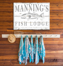 This personalized fishing sign elevates indoor/outdoor spaces with authentic lodge decor. Hand-drawn fish artwork of bass, tarpon, or redfish with your family name, established year, and custom text creates a distinctive focal point. Be surrounded by decor you LOVE! Choose premium framed canvas or durable outdoor metal. Toe Fish Art makes artisan wall art with American materials. Proudly Made in the USA, each piece is expertly constructed with genuine craftsmanship, heritage quality, and rustic charm.