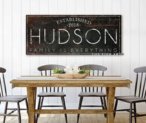 Personalized Family Name Sign with First and Last Names, Established Date, and Custom Wording Options, handmade by Toe Fish Art. Be surrounded by decor you LOVE! Choose between premium framed canvas or durable outdoor metal. Toe Fish Art makes artisan wall art with American materials. Proudly Made in the USA, each piece is expertly constructed with genuine craftsmanship, heritage quality, and rustic charm.