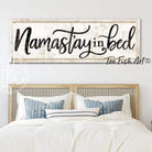 Namast'ay In Bed Sign handmade by ToeFishArt. Original, custom, personalized wall decor signs. Canvas, Wood or Metal. Rustic modern farmhouse, cottagecore, vintage, retro, industrial, Americana, primitive, country, coastal, minimalist.