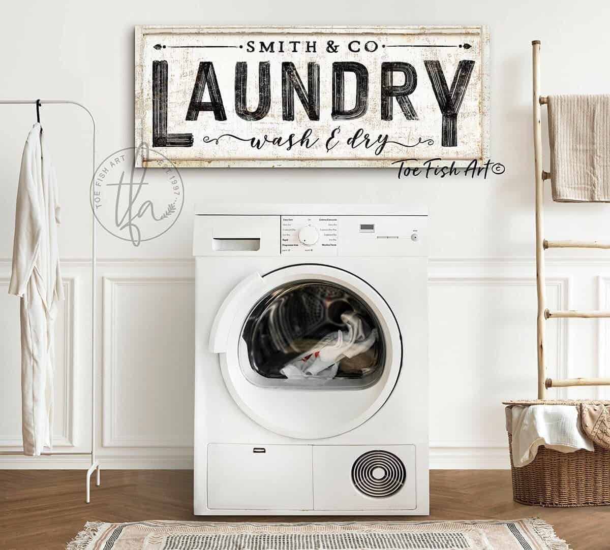 Add a personal touch to your laundry room, utility room, or mudroom with Toe Fish Art's Personalized Family Name & Co Laundry Sign with fun wording options. This piece adds vintage modern farmhouse flair to any home. Be surrounded by decor you LOVE! Choose between premium framed canvas or durable outdoor metal. Toe Fish Art makes artisan wall art with American materials. Proudly Made in the USA, each piece is expertly constructed with genuine craftsmanship, heritage quality, and rustic charm.