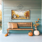 Toe Fish Art's Faith-inspired wall art featuring Psalm 107:1 ‘Give thanks to the Lord for He is good, His love endures forever’ hand-lettered on a rustic country church scene surrounded by golden autumn trees landscape painting. Handmade in the USA and constructed in framed canvas or waterproof outdoor metal. Vintage fall colors, perfect for Christian home décor, Thanksgiving, or seasonal autumn cottagecore decor.