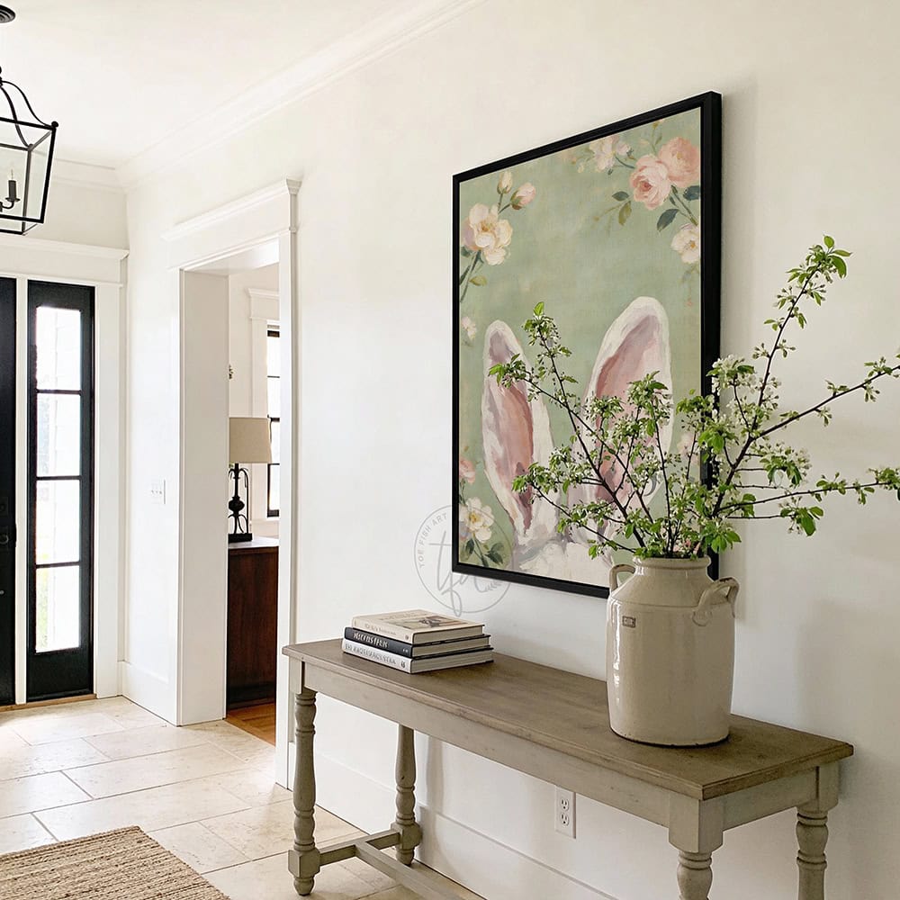 Hop into spring with this vintage floral bunny wall decor by Toe Fish Art! Using soft green and pink pastels, this cottagecore artwork brings a playful vibe with adorable bunny ears peeking up through flowers. Whether decorating a cozy bedroom, nursery, or Easter festivities and gifts, this framed piece brings instant charm. Toe Fish Art makes artisan wall décor using American sourced materials. Proudly Made in the USA and expertly constructed with genuine craftsmanship, heritage quality, and rustic charm.