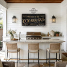 Welcome guests to your outdoor entertaining space with this personalized patio bar and grill sign by Toe Fish Art. Customize with your family name, clever welcome phrase, or business name to create distinctive decor for your deck, outdoor kitchen, or poolside bar. Available in outdoor metal or canvas. Toe Fish Art creates artisan-made wall décor using American sourced materials. Proudly Made in the USA, each sign is expertly constructed with genuine craftsmanship, heritage quality, and rustic charm.