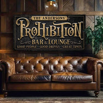 Every great bar deserves a name, and yours deserves a sign to match! This Personalized Prohibition Bar & Lounge Sign in vintage black with woodgrain or rustic gold lettering instantly transforms any space with 1920s industrial appeal. Be surrounded by decor you LOVE! Choose premium framed canvas or durable outdoor metal. Toe Fish Art makes artisan wall art with American materials. Proudly Made in the USA, each piece is expertly constructed with genuine craftsmanship, heritage quality, and rustic charm.
