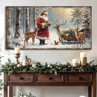 Toe Fish Art Santa Claus feeding reindeer in a snowy forest with sleigh and woodland animals, rustic Christmas wall art scene.