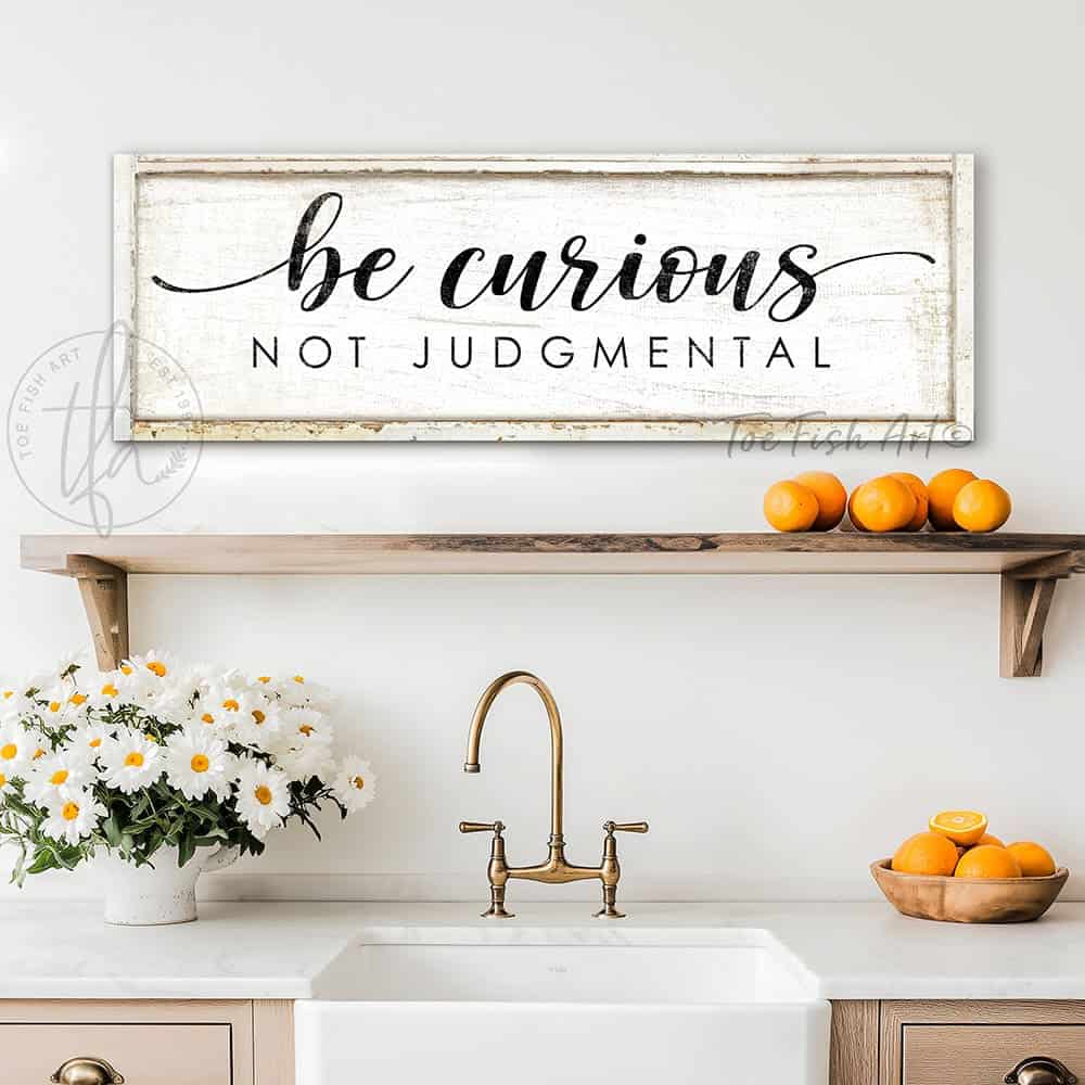 "Be Curious Not Judgmental" invites you to live with intention. This modern farmhouse wall art by Toe Fish Art serves as a reminder to approach life with kindness. Featuring neutral vintage tones that complement any space. Be surrounded by decor you LOVE! Choose premium gallery-stretched canvas or elegant framed canvas. Toe Fish Art makes artisan wall art with American materials. Proudly Made in the USA, each piece is expertly constructed with genuine craftsmanship, heritage quality, and rustic charm.