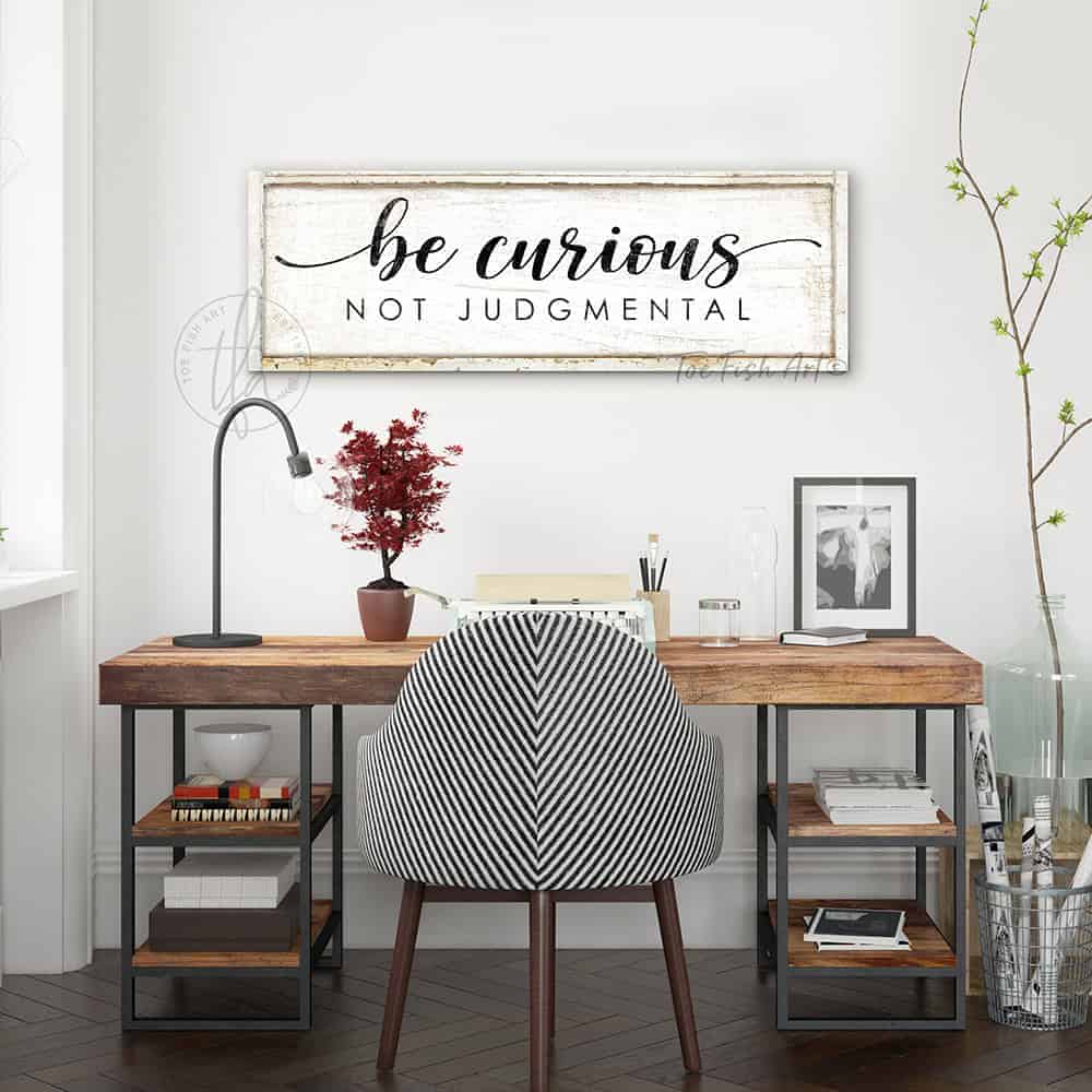 "Be Curious Not Judgmental" invites you to live with intention. This modern farmhouse wall art by Toe Fish Art serves as a reminder to approach life with kindness. Featuring neutral vintage tones that complement any space. Be surrounded by decor you LOVE! Choose premium gallery-stretched canvas or elegant framed canvas. Toe Fish Art makes artisan wall art with American materials. Proudly Made in the USA, each piece is expertly constructed with genuine craftsmanship, heritage quality, and rustic charm.