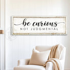 "Be Curious Not Judgmental" invites you to live with intention. This modern farmhouse wall art by Toe Fish Art serves as a reminder to approach life with kindness. Featuring neutral vintage tones that complement any space. Be surrounded by decor you LOVE! Choose premium gallery-stretched canvas or elegant framed canvas. Toe Fish Art makes artisan wall art with American materials. Proudly Made in the USA, each piece is expertly constructed with genuine craftsmanship, heritage quality, and rustic charm.