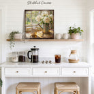The comfort of sunlight, a warm mug of coffee, and fresh flowers in bloom—this charming piece by Toe Fish Art brings instant vintage magic. A square design captures cottagecore aesthetics with a cozy neutral color palette. Be surrounded by decor you LOVE! Choose premium framed canvas or durable outdoor metal. Toe Fish Art makes artisan wall art with American materials. Proudly Made in the USA, each piece is expertly constructed with genuine craftsmanship, heritage quality, and rustic charm.