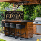 Personalized Patio Bar & Grill Sign by Toe Fish Art in vintage black and rustic gold. Add your own custom text or family name for a unique display. Ideal for summer vibes on patios, decks, outdoor kitchens, and backyard bar areas. Be surrounded by decor you LOVE! Choose between premium framed canvas or durable outdoor metal. Toe Fish Art makes artisan wall art with American materials. Proudly Made in the USA, each piece is expertly constructed with genuine craftsmanship, heritage quality, and rustic charm.