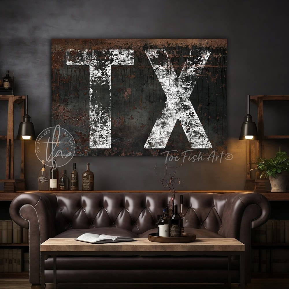 Personalized USA state location wall art featuring your custom two-letter state abbreviation on a dark, distressed industrial farmhouse background with vintage rustic charm and faded white lettering. Be surrounded by decor you LOVE! Choose between premium framed canvas or durable outdoor metal. Toe Fish Art makes artisan wall art with American materials. Proudly Made in the USA, each piece is expertly constructed with genuine craftsmanship, heritage quality, and rustic charm.