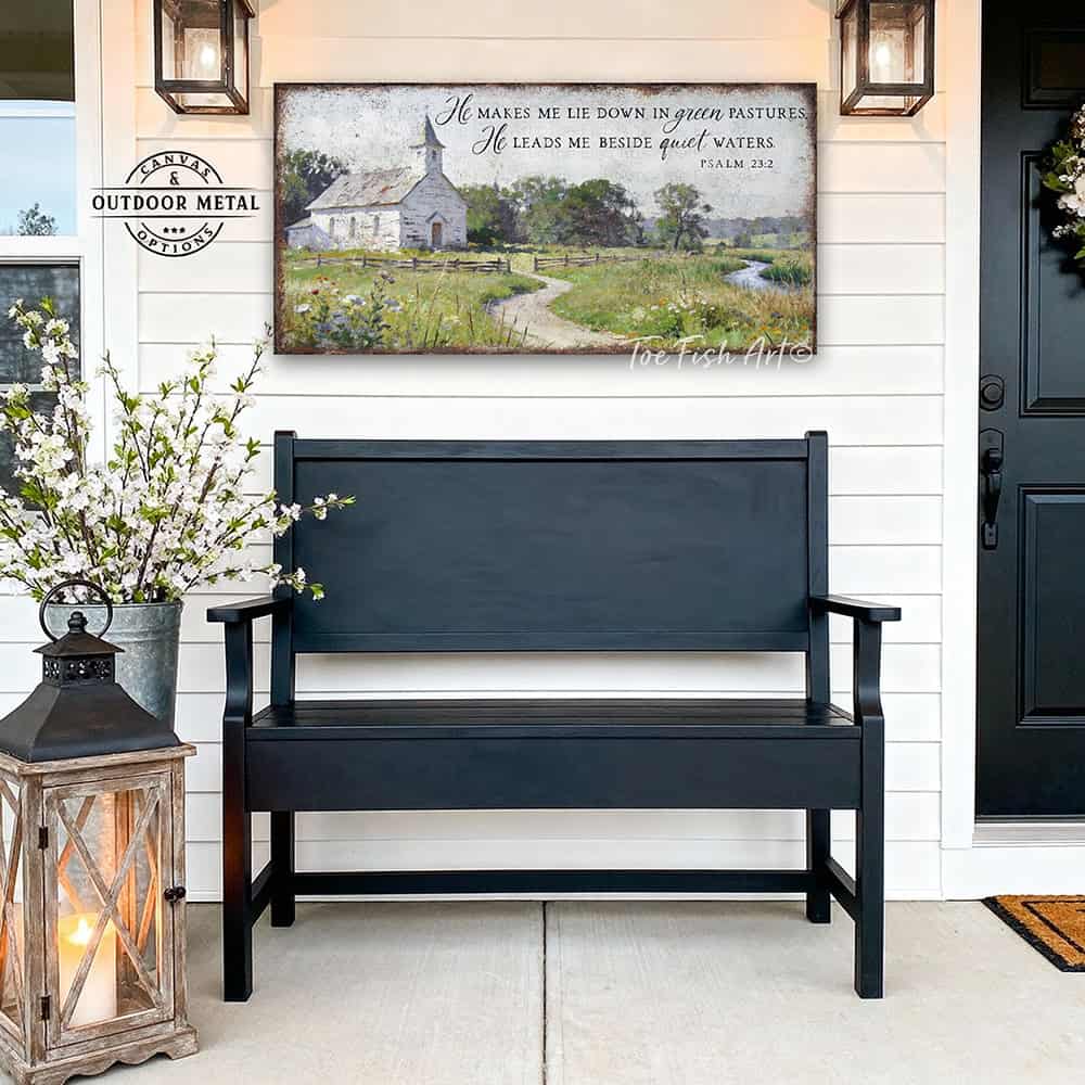 This Psalm 23:2 vintage landscape painting by Toe Fish Art captures spiritual peace through a rustic countryside pastoral church scene, featuring farmhouse cottagecore aesthetics with natural earth tones of soft greens, white, and blues. Be surrounded by decor you LOVE! Choose premium framed canvas or durable outdoor metal. Toe Fish Art makes artisan wall art with American materials. Proudly Made in the USA, each piece is expertly constructed with genuine craftsmanship, heritage quality, and rustic charm.
