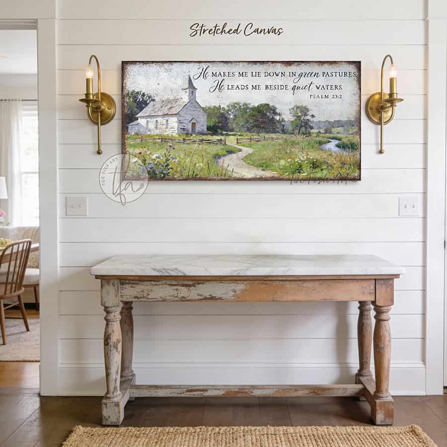This Psalm 23:2 vintage landscape painting by Toe Fish Art captures spiritual peace through a rustic countryside pastoral church scene, featuring farmhouse cottagecore aesthetics with natural earth tones of soft greens, white, and blues. Be surrounded by decor you LOVE! Choose premium framed canvas or durable outdoor metal. Toe Fish Art makes artisan wall art with American materials. Proudly Made in the USA, each piece is expertly constructed with genuine craftsmanship, heritage quality, and rustic charm.
