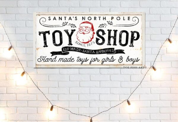 Santa's North Pole Toy Shop Sign handmade by ToeFishArt. Original, custom, personalized wall decor signs. Canvas, Wood or Metal. Rustic modern farmhouse, cottagecore, vintage, retro, industrial, Americana, primitive, country, coastal, minimalist.