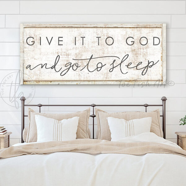 Toe Fish Art's original Faith-based bedroom wall decor sign featuring the popular quote 'Give it to God and Go to Sleep.' Available in color options of timeworn white or lightly distressed white, this hand-lettered original design comes in either framed canvas or solid aluminum metal. A comforting, clever and popular saying, perfect for creating a serene, peaceful atmosphere in your master bedroom or guest room. Built to last with genuine craftsmanship, this relevant decor adds rustic charm and heritage quality to any space. Made in the USA with durable, authentic materials for a beautiful and meaningful theme. Rustic country charm meets modern minimalist farmhouse wall decor handcrafted in durable high-quality framed canvas or sleek and solid aluminum metal, handmade in the USA from start to finish! Beautiful, stylish and timeless wall decor. Handcrafted in the USA by ToeFishArt, and built to last a lifetime by the Toe Fish Art family artisans. This beautiful original artwork adds unique eye-catching decor to any bedroom or lounging and relaxation space. Perfect for your master bedroom, guest rooms, outdoor lounge napping space or hammock area. This sign is a happy playful reminder of Christian faith and God's love. Original, custom, personalized wall decor signs. Canvas, Wood or Metal. Rustic modern farmhouse, cottagecore, vintage, retro, industrial, Americana, primitive, country, coastal, minimalist. Toe Fish Art is a USA small family woman owned business making beautiful decor since 1997.