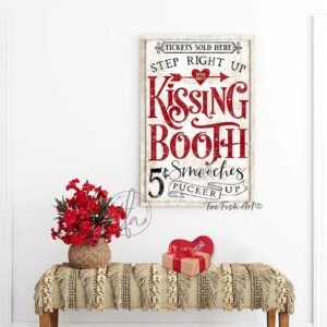 Toe Fish Art’s vintage cottage-style wall art showcases a rustic Kissing Booth sign, perfect for Valentine’s Day. Inspired by old-time fairs and carnivals, this vertical piece features a charming design advertising “5-cent smooches” in a distressed red, white, and black color palette for an authentic, nostalgic touch. This wall decor is available in numerous sizes from small to huge, and several material choices suitable for your space. Blending rustic primitive country charm with cottage farmhouse style, this handcrafted artwork is available in durable high-quality framed canvas or outdoor weatherproof solid aluminum metal. Proudly made in the USA, each piece is designed to last a lifetime by the artisans at Toe Fish Art. This beautiful artwork enhances any decor, and makes the perfect Valentine Gift, adding eye-catching appeal indoors or outdoors. It’s perfect for display in a porch, entryway, patio, lanai, deck, veranda, living room, fireplace hearth or mantel, dining room, or bedroom, or as a shelf sitter. A special reminder of the season of love, this artwork fits various styles, including rustic modern farmhouse, cottagecore, vintage, retro, industrial, Americana, primitive, country, coastal, and minimalist. Toe Fish Art is a small family, woman-owned business, creating beautiful decor for almost three decades, since 1997!