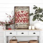 Toe Fish Art’s vintage cottage-style wall art showcases a rustic Kissing Booth sign, perfect for Valentine’s Day. Inspired by old-time fairs and carnivals, this vertical piece features a charming design advertising “5-cent smooches” in a distressed red, white, and black color palette for an authentic, nostalgic touch. This wall decor is available in numerous sizes from small to huge, and several material choices suitable for your space. Blending rustic primitive country charm with cottage farmhouse style, this handcrafted artwork is available in durable high-quality framed canvas or outdoor weatherproof solid aluminum metal. Proudly made in the USA, each piece is designed to last a lifetime by the artisans at Toe Fish Art. This beautiful artwork enhances any decor, and makes the perfect Valentine Gift, adding eye-catching appeal indoors or outdoors. It’s perfect for display in a porch, entryway, patio, lanai, deck, veranda, living room, fireplace hearth or mantel, dining room, or bedroom, or as a shelf sitter. A special reminder of the season of love, this artwork fits various styles, including rustic modern farmhouse, cottagecore, vintage, retro, industrial, Americana, primitive, country, coastal, and minimalist. Toe Fish Art is a small family, woman-owned business, creating beautiful decor for almost three decades, since 1997!