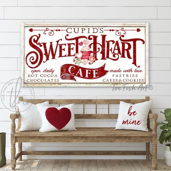 ToeFishArt Cupid's Sweetheart Cafe Canvas or Outdoor Metal Valentine's Day Seasonal Decoration Decor Gift Sign Front Door Entryway Welcome Celebrate the Season of Love Holiday handmade by ToeFishArt. Toe Fish Art is a woman-owned USA business handcrafting custom decor in the United States of America, American made for decades. Original, custom, personalized wall decor signs. Canvas, Wood or Metal. Rustic modern farmhouse, cottagecore, vintage, retro, industrial, Americana, primitive, country, coastal, minimalist.