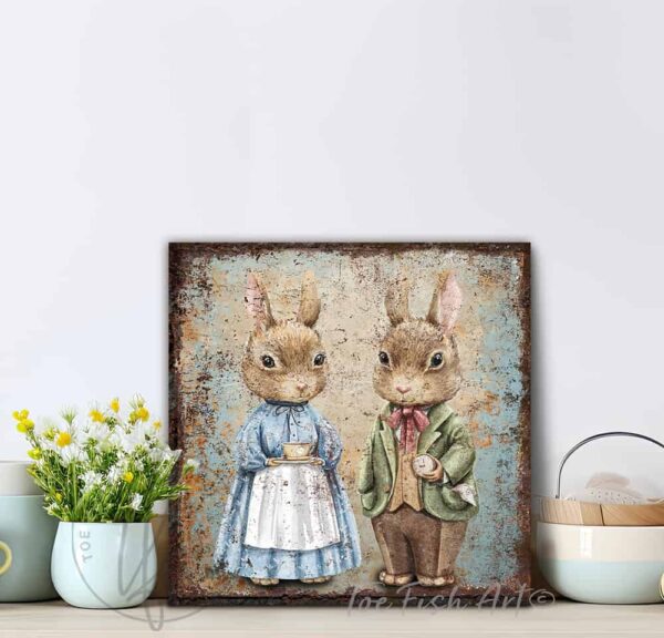 ToeFishArt Rustic Vintage Inspired Bunny Rabbits Easter Spring Cottagecore Decor Square Shaped Canvas Sign. Spring Easter entryway Seasonal Decoration for your Front Door Entryway Welcome Holiday Fresh Spring Seasonal and Colorful Decoration handmade by woman-owned USA small family business ToeFishArt. The perfect affordable decor for spring parties, Easter egg hunt gatherings. Built to last in the USA and use year after year. Original, custom, personalized wall decor signs. Canvas, Wood or Metal. Rustic modern farmhouse, cottagecore, vintage, retro, industrial, Americana, primitive, country, coastal, minimalist.