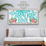 Toe Fish Art Custom Personalize-able Paradise Cove Sign handcrafted in the USA made of Canvas or Outdoor Weatherproof Metal, Welcome to Paradise Cove, colorful pink yellow & green Hibiscus Flowers Tropical Beachy Artwork. Popular sayings like Relax & Enjoy Swimming Grilling Chilling, Proudly Serving Whatever You Brought. Color options! White with Aqua Pool Blue lettering vintage tropical cottage patio sign, handmade by ToeFishArt. Outdoor Exterior Commercial-Grade waterproof and weatherproof durable solid Metal Sign handmade in the USA from start to finish, and built to last a lifetime by the Toe Fish Art family artisans. Add your custom Family Name and established date to this beautiful original artwork for unique eye-catching decor indoors or outdoors. Original, custom, personalized wall decor signs. Canvas, Wood or Metal. Rustic modern farmhouse, cottagecore, vintage, retro, industrial, Americana, primitive, country, coastal, minimalist.