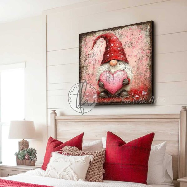 Toe Fish Art's charming vintage cottage-style wall art featuring a rustic gnome, perfect for Valentine's Day. This square-shaped decoration showcases a delightful gnome with a red hat and white beard, holding a pink heart, all set against a worn rustic background in a lovely red and pink color palette. Handcrafted in the USA, this durable artwork is available in high-quality framed canvas or weatherproof solid aluminum metal, ensuring it lasts a lifetime. Ideal for enhancing your porch, entryway, living room, or romantic bedroom setting, this unique piece adds seasonal charm and eye-catching appeal to any indoor or outdoor space. Original, custom, personalized wall decor signs. Canvas, Wood or Metal. Rustic modern farmhouse, cottagecore, vintage, retro, industrial, Americana, primitive, country, coastal, minimalist. Toe Fish Art is a USA small family woman owned business making beautiful decor since 1997.