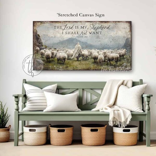 Toe Fish Art's artisan-made, faith-based, framed canvas or outdoor waterproof metal wall decor, expertly made with American-sourced materials. This premium, handcrafted piece features the painting of a shepherd dressed in flowing white garments walking peacefully among a herd of sheep in a lush green meadow. The scene is surrounded by majestic rocky mountains under a vibrant blue sky filled with puffy white and gray clouds, evoking a serene and pastoral atmosphere, with the hand-lettered Bible verse 'The Lord is My Shepherd I Shall Not Want' – Psalm 23:1. Built to last with genuine craftsmanship, this relevant decor adds rustic charm and heritage quality to any space. Made in the USA with durable, authentic materials for a beautiful and meaningful display. Rustic country charm meets Modern Farmhouse Cottagecore wall decor handcrafted in durable high-quality framed canvas or outdoor weatherproof solid aluminum metal, handmade in the USA from start to finish! Beautiful, stylish and timeless wall decor painting. Handcrafted in the USA by ToeFishArt, and built to last a lifetime by the Toe Fish Art family artisans. This beautiful original artwork adds unique eye-catching decor indoors or outdoors. Add instant outdoor curb appeal to your home or vacation house entryway! Perfect for your porch, entryway, patio, lanai, deck, garden, veranda, living room, fireplace hearth or mantel, wall hanging or shelf sitter, dining room, kitchen or bedroom. This painting is a beautiful reminder of Christian faith and God's love. Original, custom, personalized wall decor signs. Canvas, Wood or Metal. Rustic modern farmhouse, cottagecore, vintage, retro, industrial, Americana, primitive, country, coastal, minimalist. Toe Fish Art is a USA small family woman owned business making beautiful decor since 1997.