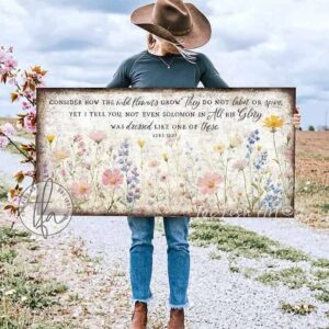 Toe Fish Art's artisan-made framed canvas or outdoor waterproof metal wall decor, expertly made with American-sourced materials. This premium, handcrafted piece features a timeless painting of pastel wildflowers with the hand-lettered Bible verse ‘Consider how the wildflowers grow’ (Luke 12:27). Built to last with genuine craftsmanship, it adds rustic charm and heritage quality to any space. Made in the USA with durable, authentic materials for a beautiful and meaningful display. Rustic Country and Modern Farmhouse wall decor handcrafted in durable high-quality framed canvas or outdoor weatherproof solid aluminum metal, handmade in the USA from start to finish! Beautiful, stylish and timeless floral wall decor painting. Handcrafted in the USA by ToeFishArt, and built to last a lifetime by the Toe Fish Art family artisans. This beautiful original artwork adds unique eye-catching decor indoors or outdoors. Add instant outdoor curb appeal to your home or vacation house entryway! Perfect for your porch, entryway, patio, lanai, deck, garden, veranda, living room, fireplace hearth or mantel, wall hanging or shelf sitter, dining room or bedroom. This painting is a beautiful reminder of Christian faith and God's love with the promise of Spring renewal. Original, custom, personalized wall decor signs. Canvas, Wood or Metal. Rustic modern farmhouse, cottagecore, vintage, retro, industrial, Americana, primitive, country, coastal, minimalist. Toe Fish Art is a USA small family woman owned business making beautiful decor since 1997.