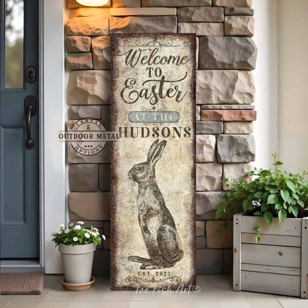 Toe Fish Art vintage-style 'Welcome to Easter' vertical porch leaner and greeter sign, personalized with family name and year. Features worn rustic white background and powder blue accents, with dark charcoal gray lettering and charming vintage bunny rabbit hand-drawn sketched artwork. Available in framed canvas or durable outdoor metal, perfect for entryways, gardens, patios or outdoor walkways. Toe Fish Art's artisan-made framed canvas or outdoor waterproof metal wall decor, expertly made with American-sourced materials. This premium, handcrafted piece can be customized to fit your style. Built to last with genuine craftsmanship, this nostalgic, heirloom decor adds rustic charm and heritage quality to any space. Made in the USA with durable, authentic materials for a beautiful and meaningful display to last year after year. Rustic country charm meets Modern Farmhouse Cottagecore wall decor handcrafted in durable high-quality framed canvas or outdoor weatherproof solid aluminum metal, handmade in the USA from start to finish! Beautiful, stylish and timeless wall decor artwork. Handcrafted in the USA by ToeFishArt, and built to last a lifetime by the Toe Fish Art family artisans. This beautiful original artwork adds unique eye-catching decor indoors or outdoors. Add instant outdoor holiday curb appeal to your home! Perfect for your porch, entryway, foyer, patio, lanai, deck, garden, veranda, kitchen or dining room. This special holiday decoration is a beautiful reminder of spring celebrations and renewal. Original, custom, personalized wall decor signs. Canvas, Wood or Metal. Rustic modern farmhouse, cottagecore, vintage, retro, industrial, Americana, primitive, country, coastal, minimalist. Toe Fish Art is a USA small family woman owned business making beautiful decor since 1997.
