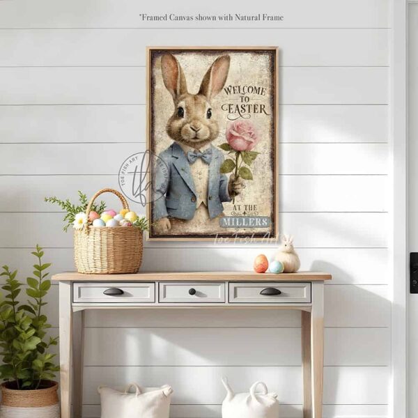 Toe Fish Art vintage-style 'Welcome to Easter' vertical entryway porch greeter sign, personalized with family name or other phrase. Features worn rustic white background and powder blue accents, with dark charcoal gray lettering and charming vintage bunny rabbit wearing a powder blue and white tuxedo holding a pink rose hand-drawn sketched artwork. Available in framed canvas or durable outdoor metal, perfect for porches, entryways, gardens, patios or outdoor walkways. Toe Fish Art's artisan-made framed canvas or outdoor waterproof metal wall decor, expertly made with American-sourced materials. This premium, handcrafted piece can be customized to fit your style. Built to last with genuine craftsmanship, this nostalgic, heirloom decor adds rustic charm and heritage quality to any space. Made in the USA with durable, authentic materials for a beautiful and meaningful display to last year after year. Rustic country charm meets Modern Farmhouse Cottagecore wall decor handcrafted in durable high-quality framed canvas or outdoor weatherproof solid aluminum metal, handmade in the USA from start to finish! Beautiful, stylish and timeless wall decor artwork. Handcrafted in the USA by ToeFishArt, and built to last a lifetime by the Toe Fish Art family artisans. This beautiful original artwork adds unique eye-catching decor indoors or outdoors. Add instant outdoor holiday curb appeal to your home! Perfect for your porch, entryway, foyer, patio, lanai, deck, garden, veranda, kitchen or dining room. This special holiday decoration is a beautiful reminder of spring celebrations and renewal. Original, custom, personalized wall decor signs. Canvas, Wood or Metal. Rustic modern farmhouse, cottagecore, vintage, retro, industrial, Americana, primitive, country, coastal, minimalist. Toe Fish Art is a USA small family woman owned business making beautiful decor since 1997.