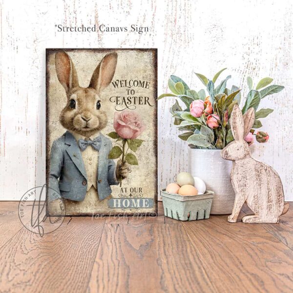 Toe Fish Art vintage-style 'Welcome to Easter' vertical entryway porch greeter sign, personalized with family name or other phrase. Features worn rustic white background and powder blue accents, with dark charcoal gray lettering and charming vintage bunny rabbit wearing a powder blue and white tuxedo holding a pink rose hand-drawn sketched artwork. Available in framed canvas or durable outdoor metal, perfect for porches, entryways, gardens, patios or outdoor walkways. Toe Fish Art's artisan-made framed canvas or outdoor waterproof metal wall decor, expertly made with American-sourced materials. This premium, handcrafted piece can be customized to fit your style. Built to last with genuine craftsmanship, this nostalgic, heirloom decor adds rustic charm and heritage quality to any space. Made in the USA with durable, authentic materials for a beautiful and meaningful display to last year after year. Rustic country charm meets Modern Farmhouse Cottagecore wall decor handcrafted in durable high-quality framed canvas or outdoor weatherproof solid aluminum metal, handmade in the USA from start to finish! Beautiful, stylish and timeless wall decor artwork. Handcrafted in the USA by ToeFishArt, and built to last a lifetime by the Toe Fish Art family artisans. This beautiful original artwork adds unique eye-catching decor indoors or outdoors. Add instant outdoor holiday curb appeal to your home! Perfect for your porch, entryway, foyer, patio, lanai, deck, garden, veranda, kitchen or dining room. This special holiday decoration is a beautiful reminder of spring celebrations and renewal. Original, custom, personalized wall decor signs. Canvas, Wood or Metal. Rustic modern farmhouse, cottagecore, vintage, retro, industrial, Americana, primitive, country, coastal, minimalist. Toe Fish Art is a USA small family woman owned business making beautiful decor since 1997.