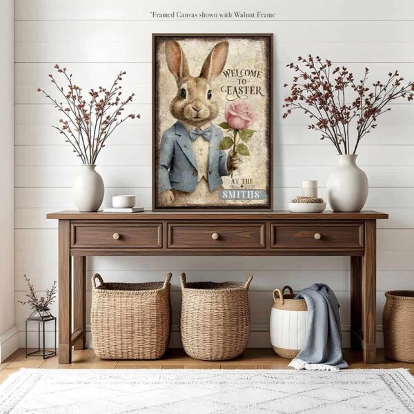 Toe Fish Art vintage-style 'Welcome to Easter' vertical entryway porch greeter sign, personalized with family name or other phrase. Features worn rustic white background and powder blue accents, with dark charcoal gray lettering and charming vintage bunny rabbit wearing a powder blue and white tuxedo holding a pink rose hand-drawn sketched artwork. Available in framed canvas or durable outdoor metal, perfect for porches, entryways, gardens, patios or outdoor walkways. Toe Fish Art's artisan-made framed canvas or outdoor waterproof metal wall decor, expertly made with American-sourced materials. This premium, handcrafted piece can be customized to fit your style. Built to last with genuine craftsmanship, this nostalgic, heirloom decor adds rustic charm and heritage quality to any space. Made in the USA with durable, authentic materials for a beautiful and meaningful display to last year after year. Rustic country charm meets Modern Farmhouse Cottagecore wall decor handcrafted in durable high-quality framed canvas or outdoor weatherproof solid aluminum metal, handmade in the USA from start to finish! Beautiful, stylish and timeless wall decor artwork. Handcrafted in the USA by ToeFishArt, and built to last a lifetime by the Toe Fish Art family artisans. This beautiful original artwork adds unique eye-catching decor indoors or outdoors. Add instant outdoor holiday curb appeal to your home! Perfect for your porch, entryway, foyer, patio, lanai, deck, garden, veranda, kitchen or dining room. This special holiday decoration is a beautiful reminder of spring celebrations and renewal. Original, custom, personalized wall decor signs. Canvas, Wood or Metal. Rustic modern farmhouse, cottagecore, vintage, retro, industrial, Americana, primitive, country, coastal, minimalist. Toe Fish Art is a USA small family woman owned business making beautiful decor since 1997.