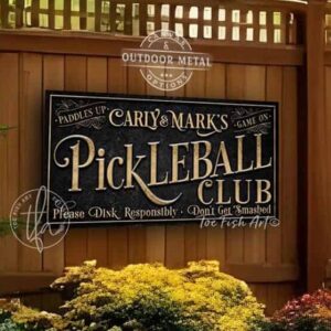 Toe Fish Art’s personalized "Pickleball Club” sign features the phrase ‘Please Dink Responsibly—Don’t Get Smashed’ in rustic gold style lettering on a vintage slate black background. Available as a beautiful framed canvas or durable and sleek outdoor metal sign, this custom wall art adds humor and charm to your game space or post-play lounge area. Made in America and built to last, perfect for pickleball lovers, sports decor, and custom man cave or backyard court accents. This premium printed sign showcases a detailed, original design ideal for upgrading your sports bar, game room, courtside seating, outdoor entertaining space, or backyard decor. Customized sign, personalized with family name or favorite saying and custom wording options. Available in a huge array of sizes, Toe Fish Art's artisan-made wall decor is expertly made in America with American-sourced materials. This high-end, handcrafted piece can be customized to fit your style! Built to last with genuine craftsmanship, this heirloom decor adds rustic cottage charm and heritage quality to any space. Made in the USA with durable, authentic materials for a beautiful and meaningful display to last year after year. Modern Farmhouse Cottagecore wall decor handcrafted in durable high-quality framed canvas or indoor-outdoor weatherproof solid aluminum metal, handmade in the USA from start to finish! Beautiful, stylish and timeless wall decor artwork. Handmade in the USA by ToeFishArt, and built to last a lifetime by the Toe Fish Art family artisans. This beautiful original artwork adds unique eye-catching decor indoors or outdoors. Perfect for your game room, man cave, sports bar post-game lounge, basement bar, garage bar, patio, lanai, deck, or any outdoor living space. This special decoration is a fun way to celebrate your favorite game with friends. Original, custom, personalized wall decor signs. Canvas, Wood or Metal. Rustic modern farmhouse, cottagecore, vintage, retro, industrial, Americana, primitive, country, coastal, minimalist. Toe Fish Art is a USA small family woman owned business making beautiful decor since 1997.