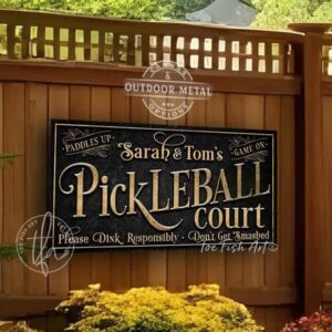 Toe Fish Art’s personalized "Pickleball Court" sign features the phrase ‘Please Dink Responsibly—Don’t Get Smashed’ in rustic gold lettering on a vintage slate black background. Available as a beautiful framed canvas or durable and sleek outdoor metal sign, this custom wall art adds humor and charm to your game space. Made in America and built to last, perfect for pickleball lovers, sports decor, and custom man cave or backyard court accents. This premium printed sign showcases a detailed, original design ideal for upgrading your sports bar, game room, outdoor entertaining space, or backyard decor. Customized sign, personalized with family name or favorite saying and custom wording options. Available in a huge array of sizes. Toe Fish Art's artisan-made wall decor is expertly made with American-sourced materials. This high-end, handcrafted piece can be customized to fit your style. Built to last with genuine craftsmanship, this heirloom decor adds rustic cottage charm and heritage quality to any space. Made in the USA with durable, authentic materials for a beautiful and meaningful display to last year after year. Modern Farmhouse Cottagecore wall decor handcrafted in durable high-quality framed canvas or indoor-outdoor weatherproof solid aluminum metal, handmade in the USA from start to finish! Beautiful, stylish and timeless wall decor artwork. Handmade in the USA by ToeFishArt, and built to last a lifetime by the Toe Fish Art family artisans. This beautiful original artwork adds unique eye-catching decor indoors or outdoors. Perfect for your game room, man cave, sports bar post-game lounge, basement bar, garage bar, patio, lanai, deck, or any outdoor living space. This special decoration is a fun way to celebrate your favorite game with friends. Original, custom, personalized wall decor signs. Canvas, Wood or Metal. Rustic modern farmhouse, cottagecore, vintage, retro, industrial, Americana, primitive, country, coastal, minimalist. Toe Fish Art is a USA small family woman owned business making beautiful decor since 1997.