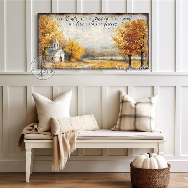 Toe Fish Art's Faith-inspired wall art featuring Psalm 107:1 ‘Give thanks to the Lord for He is good, His love endures forever’ hand-lettered on a rustic country church scene surrounded by golden autumn trees landscape painting. Handmade in the USA and constructed in framed canvas or waterproof outdoor metal. Vintage fall colors, perfect for Christian home décor, Thanksgiving, or seasonal autumn cottagecore decor.