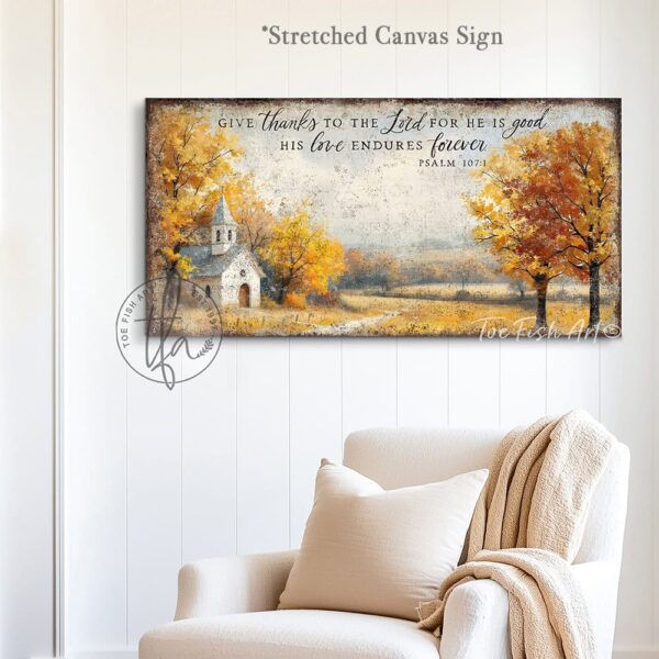 Toe Fish Art's Faith-inspired wall art featuring Psalm 107:1 ‘Give thanks to the Lord for He is good, His love endures forever’ hand-lettered on a rustic country church scene surrounded by golden autumn trees landscape painting. Handmade in the USA and constructed in framed canvas or waterproof outdoor metal. Vintage fall colors, perfect for Christian home décor, Thanksgiving, or seasonal autumn cottagecore decor.