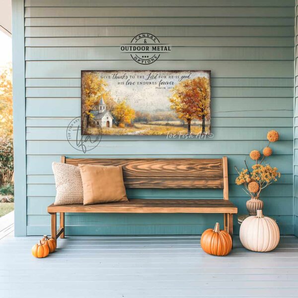Toe Fish Art's Faith-inspired wall art featuring Psalm 107:1 ‘Give thanks to the Lord for He is good, His love endures forever’ hand-lettered on a rustic country church scene surrounded by golden autumn trees landscape painting. Handmade in the USA and constructed in framed canvas or waterproof outdoor metal. Vintage fall colors, perfect for Christian home décor, Thanksgiving, or seasonal autumn cottagecore decor.