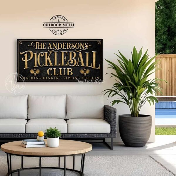 Toe Fish Art’s personalized "Pickleball Club” sign features the phrase "Smashin' Dinkin' Sippin' Chillin’" in rustic gold style lettering on a vintage slate black background. Available as a beautiful framed canvas sign or durable and sleek outdoor metal sign, this custom wall art decor adds humor and charm to your game space or post-play lounge area. Made in America and built to last, perfect for pickleball lovers, sports decor, and custom man cave or backyard court accents. This premium printed sign showcases a detailed, original design ideal for upgrading your sports bar, game room, court-side seating, outdoor entertaining space, or backyard decor. Customized sign, personalized with family name or favorite saying and custom wording options. Available in a huge array of sizes, Toe Fish Art's artisan-made wall decor is expertly made in America with American-sourced materials. This high-end, handcrafted piece can be customized to fit your style! Built to last with genuine craftsmanship, this heirloom decor adds rustic cottage charm and heritage quality to any space. Made in the USA with durable, authentic materials for a beautiful and meaningful display to last year after year. Modern Farmhouse Cottagecore wall decor handcrafted in durable high-quality framed canvas or indoor-outdoor weatherproof solid aluminum metal, handmade in the USA from start to finish! Beautiful, stylish and timeless wall decor artwork. Handmade in the USA by ToeFishArt, and built to last a lifetime by the Toe Fish Art family artisans. This beautiful original artwork adds unique eye-catching decor indoors or outdoors. Perfect for your game room, man cave, sports bar post-game lounge, basement bar, garage bar, patio, lanai, deck, or any outdoor living space. This special decoration is a fun way to celebrate your favorite game with friends. Original, custom, personalized wall decor signs. Canvas, Wood or Metal. Rustic modern farmhouse, cottagecore, vintage, retro, industrial, Americana, primitive, country, coastal, minimalist. Toe Fish Art is a USA small family woman owned business making beautiful decor since 1997.