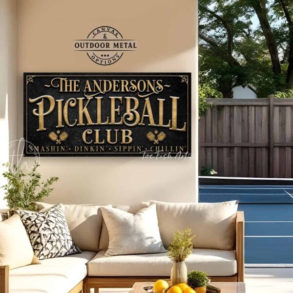 Toe Fish Art’s personalized "Pickleball Club” sign features the phrase "Smashin' Dinkin' Sippin' Chillin’" in rustic gold style lettering on a vintage slate black background. Available as a beautiful framed canvas sign or durable and sleek outdoor metal sign, this custom wall art decor adds humor and charm to your game space or post-play lounge area. Made in America and built to last, perfect for pickleball lovers, sports decor, and custom man cave or backyard court accents. This premium printed sign showcases a detailed, original design ideal for upgrading your sports bar, game room, court-side seating, outdoor entertaining space, or backyard decor. Customized sign, personalized with family name or favorite saying and custom wording options. Available in a huge array of sizes, Toe Fish Art's artisan-made wall decor is expertly made in America with American-sourced materials. This high-end, handcrafted piece can be customized to fit your style! Built to last with genuine craftsmanship, this heirloom decor adds rustic cottage charm and heritage quality to any space. Made in the USA with durable, authentic materials for a beautiful and meaningful display to last year after year. Modern Farmhouse Cottagecore wall decor handcrafted in durable high-quality framed canvas or indoor-outdoor weatherproof solid aluminum metal, handmade in the USA from start to finish! Beautiful, stylish and timeless wall decor artwork. Handmade in the USA by ToeFishArt, and built to last a lifetime by the Toe Fish Art family artisans. This beautiful original artwork adds unique eye-catching decor indoors or outdoors. Perfect for your game room, man cave, sports bar post-game lounge, basement bar, garage bar, patio, lanai, deck, or any outdoor living space. This special decoration is a fun way to celebrate your favorite game with friends. Original, custom, personalized wall decor signs. Canvas, Wood or Metal. Rustic modern farmhouse, cottagecore, vintage, retro, industrial, Americana, primitive, country, coastal, minimalist. Toe Fish Art is a USA small family woman owned business making beautiful decor since 1997.
